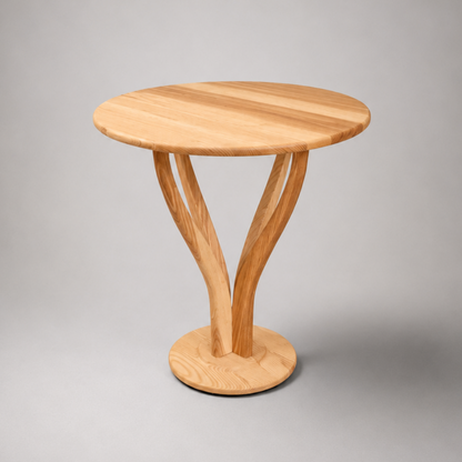 A small round wooden side table with a natural oak finish, featuring three curved legs that converge into a circular base, set against a neutral gray background.